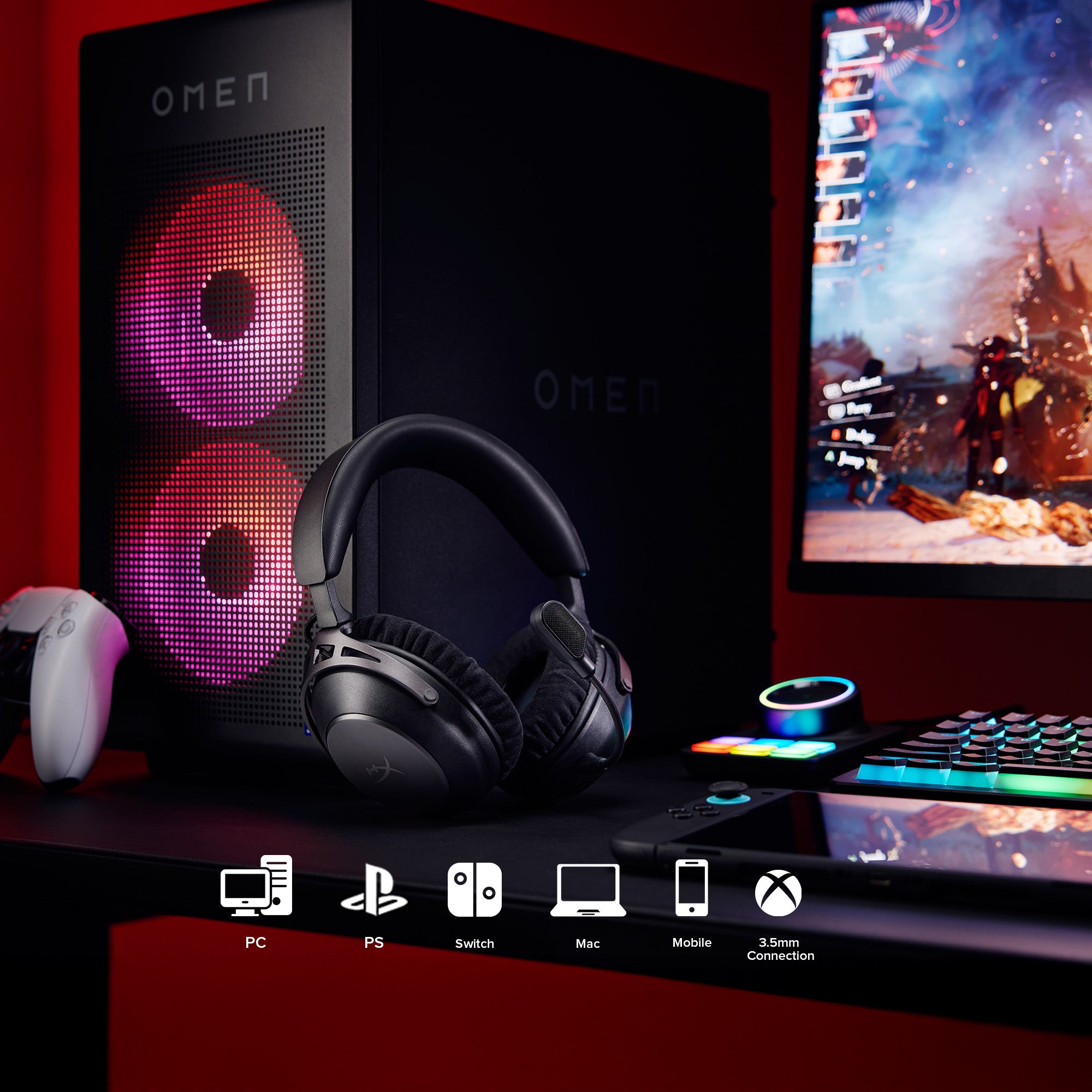 Gaming setup with OMEN computer, cloud alpha 2 wireless gaming headphones, and monitor on a desk.